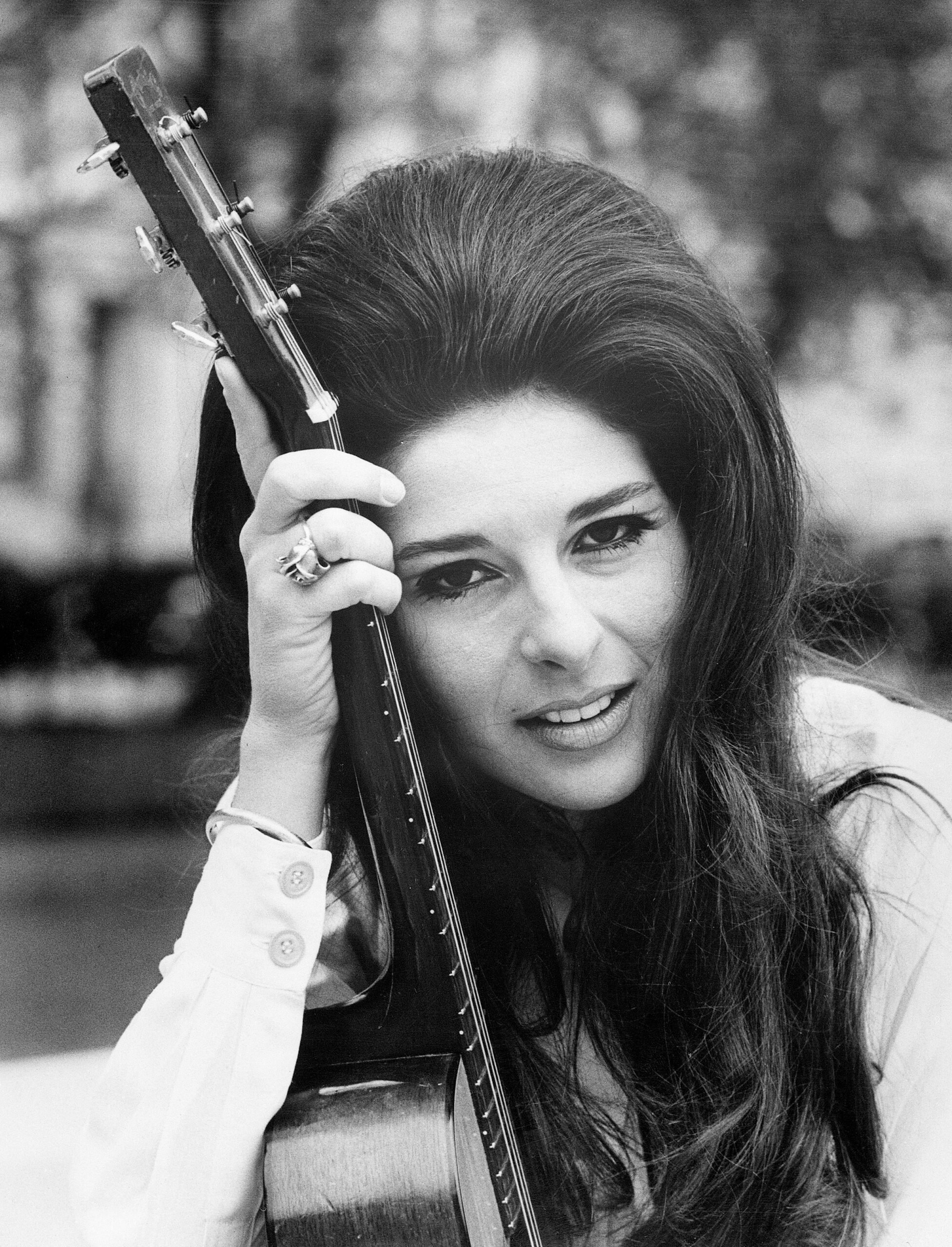 Glamourous American singing star pictured with her guitar in London, May 27, is Bobbie Gentry, who has arrived in the United Kingdom to film a BBC television and radio show. During her six weeks stay, Bobbie will cross the continent three times to star in the Olympia and Paris and film two TV shows, one in Hamburg, the other in Holland. Bobbie's multi-million selling hit, "Ode to Billie Joe," won her three Grammy Awards.