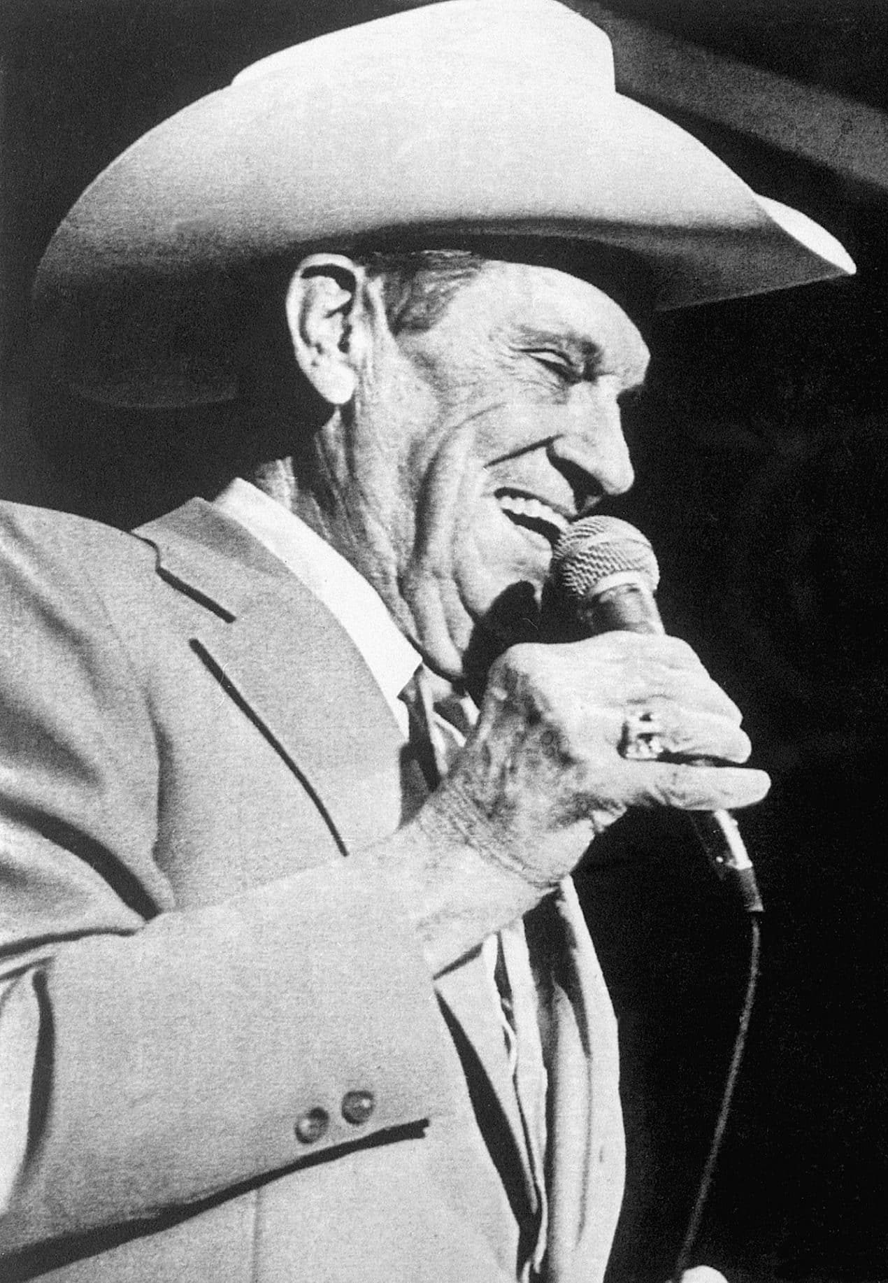 (Original Caption) 8/7/1981-Las Vegas, NV- Country Western great Ernest Tubb makes a surprise appearance at the Riviera Hotel debut of Loretta Lynn, recalling the couple's first appearance at the Grand Ole Opry in Nashville. The couple, the No. 1 country western duet for four years, sang "We're Not Kids Anymore" and "Sweet Thing."